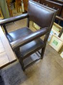 Set of five dining chairs having leather seats and backs with studs to the edges and being decorated