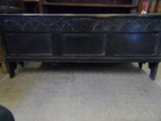 An 18th century long plank oak coffer having candle box and divider to the interior, the panelled