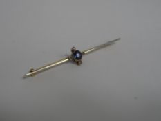 A white gold faced sapphire and diamond stick pin.