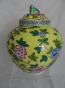 Oriental style ginger jar of Famille Rose design depicting chrysanthemums and tree peonies with a