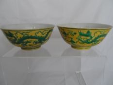 Pair of Chinese yellow and green bowls depicting scroll clouds and chasing dragons, Chenghua 1465-