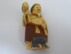 Two Japanese Netsuke both depicting wizened men, one figure is stained with character marks to