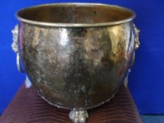 Antique brass coal / log bin being on claw feet and having lion handles