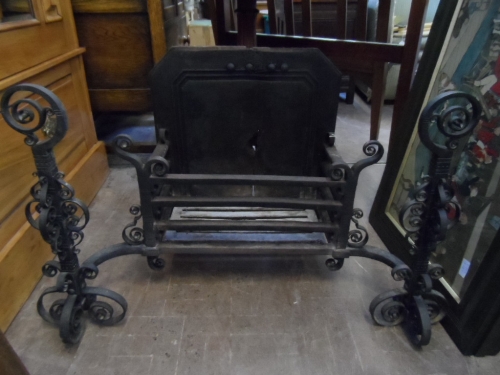 A bespoke wrought iron fire basket having scroll work decoration to each side, approx. 21 x 88 x