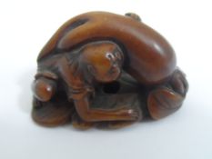 Japanese wooden Netsuke, the carving depicting a nomadic family, character marks to base together