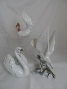 Lladro porcelain figures including a Swan, swimming with wings arched, 19 cms high, together with
