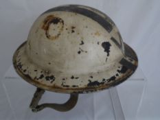 A vintage World War II air raid warden`s helmet
