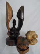 Three unusual root wooden carvings including two grieving souls, and a hand carved winged figure and