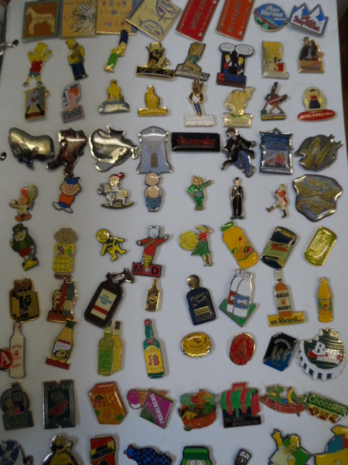 Two albums of enamel pin badges mostly French.