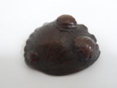 Three Japanese wooden Netsuke including an Abalone shell, an intricately carved toad, character