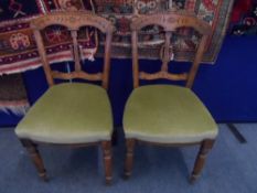 Set of four Edwardian style chairs the chairs feature ornate foliate carving to back rest.