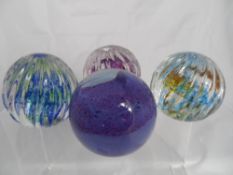 Caithness Paperweights, a collection of four paperweights including three Optix and one Blush. (4)