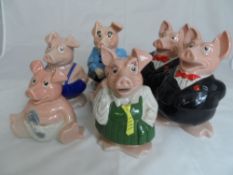 Seven Wade Nat West Pigs together with a Toby jug (8)