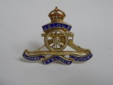 A Royal Artillery badge being 9 ct hallmarked gold and enamel.