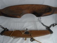 A vintage wooden yoke with chains together with a wooden piece of horse harness (2)