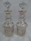 Pair of Continental cut glass decanters, the gilded decanters with original gilded tops.