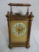 A French brass carriage clock together with a Kendal and Dent pocket watch.