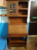 Arts and Crafts Bureau bookcase , the top having a glazed cupboard to one side and open shelves to