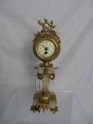 A continental single column marble and brass clock, the black plate having cross arrows inscribed to