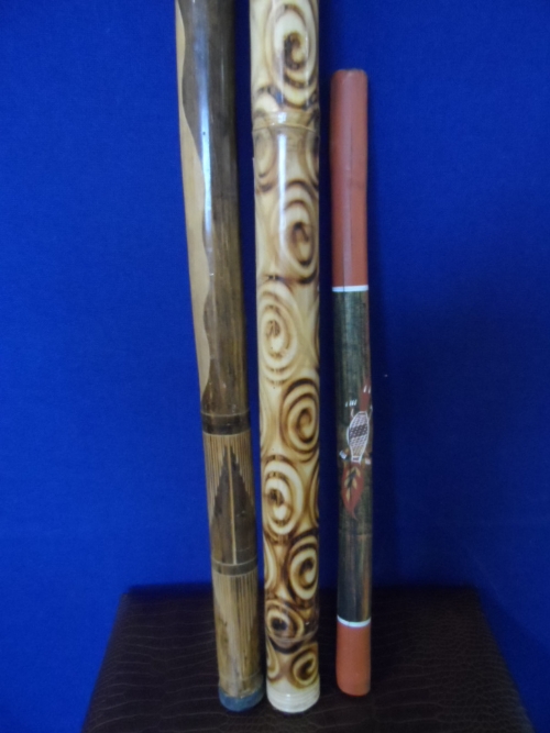 Three aboriginal didgeridoos approximate length 120 cms, 119 cms, 70 cms.