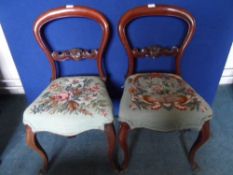 Six Victorian mahogany balloon back dining chairs with tapestry seats.