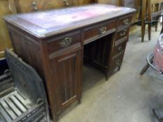 Edwardian leather topped desk, the left hand pedestal having a single drawer and cupboard, the right