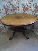 Victorian supper table being tilt top oval mahogany on a centre column and four splayed feet and