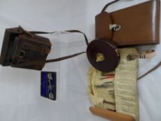 A collection of misc. items including leather bound tape measures, Dienst-glas III 18 binoculars,