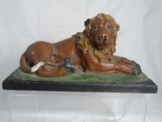 Victorian hand painted carved Cotswold Stone doorstop depicting a reclining lion.