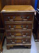 Yew wood chest of drawers having four drawers with drop handles on bracket feet, approx. 47 x 34 x