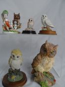 Five Resin Figures of Owls together with a figure of a boy with his dogs. (5)