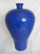 Chinese large blue vase having foliate design with marks to the neck, approx. 42 cms high.