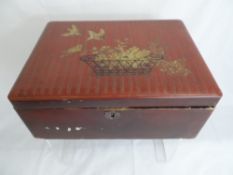 Vintage black and red lacquer oriental box having gilded picture depicting birds and flowers to top,