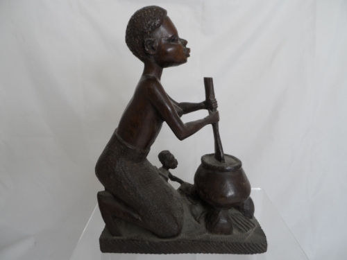 African figure of an old bearded man together with a carved figure of a woman and her child at