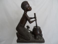 African figure of an old bearded man together with a carved figure of a woman and her child at