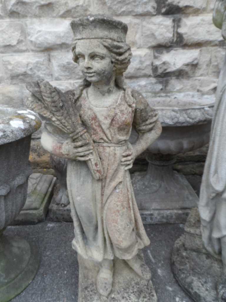 A Stone Garden Statue; depicting Summer, the statue being on a plinth, approx. 77 cms high