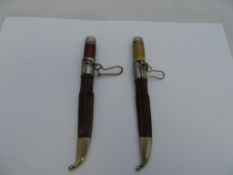 Two antique Middle Eastern miniature swords, the swords in original leather scabbards.