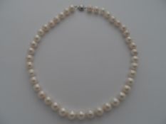A freshwater cultured pearl necklace, approx. 32 cms, in a green presentation box.