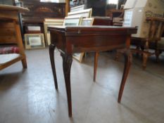 An Edwardian Mahogany Envelope Card Table; the table legs having carved decoration to the tops,