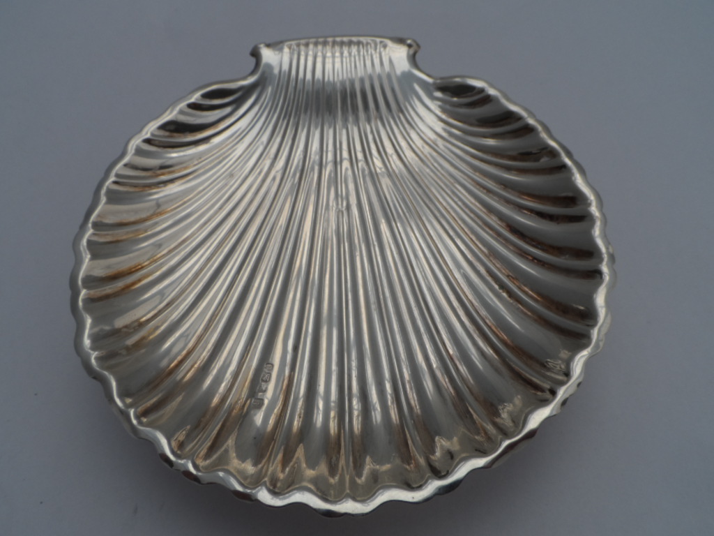 Solid silver bon bon dish, the shell shaped bon bon dish on ball feet, m.m FB Co Ltd dated 1899,