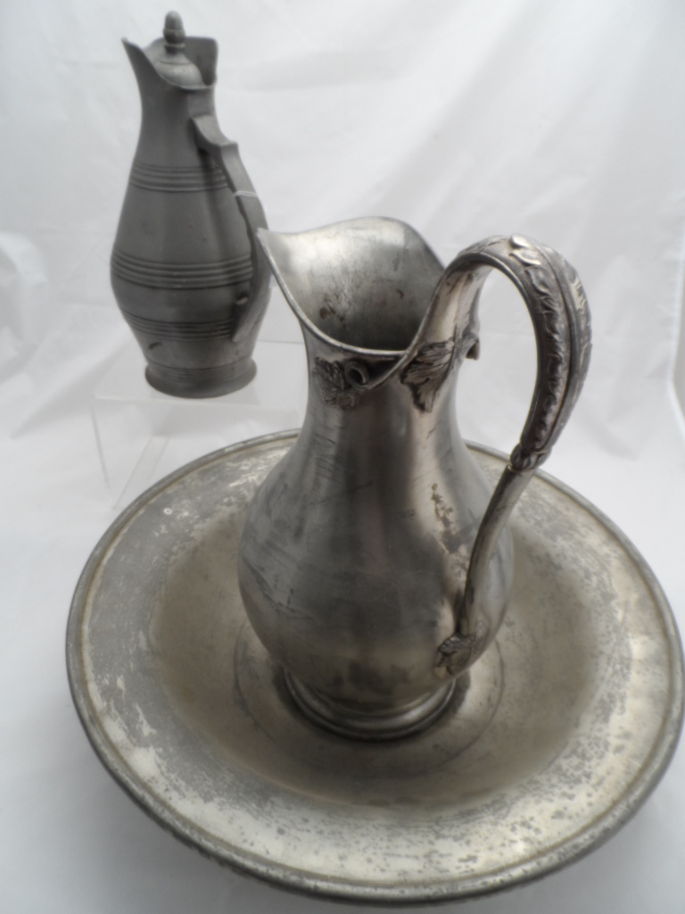 A gun metal jug and wash basin, manufactured and plated by Reed and Barton together with one other