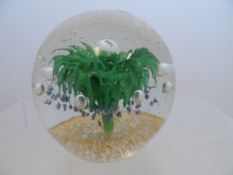 A Large Glass Paperweight, having green floral design