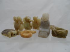 A collection of miscellaneous hard stone and other carvings including Buddah, Ciccada,mythic figures