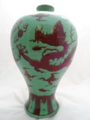 Chinese Baluster Vase, the vase having green ground with chestnut cloud scrolls, chasing dragons and