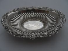 A Solid Silver Bon Bon Dish; the ornate Bon Bon dish having floral and scroll rim with ribboned