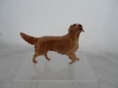 Beswick figure of a golden retriever together with a Royal Doulton figure of a golden retriever.