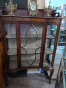 An Edwardian Double Bow Fronted Display Cabinet - the cabinet being of inlaid mahogany on cabriole