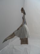 A Nao Figure of a Ballerina the seated ballerina measures 38 cms.