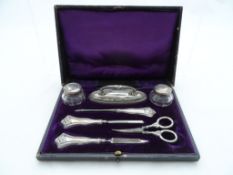 A Silver Manicure Set; the set comprising two lidded pots and five accoutrements in the original