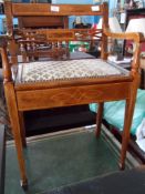 An Edwardian Mahogany Inlaid Piano Stool; the stool having an inlaid back with arm rests and music